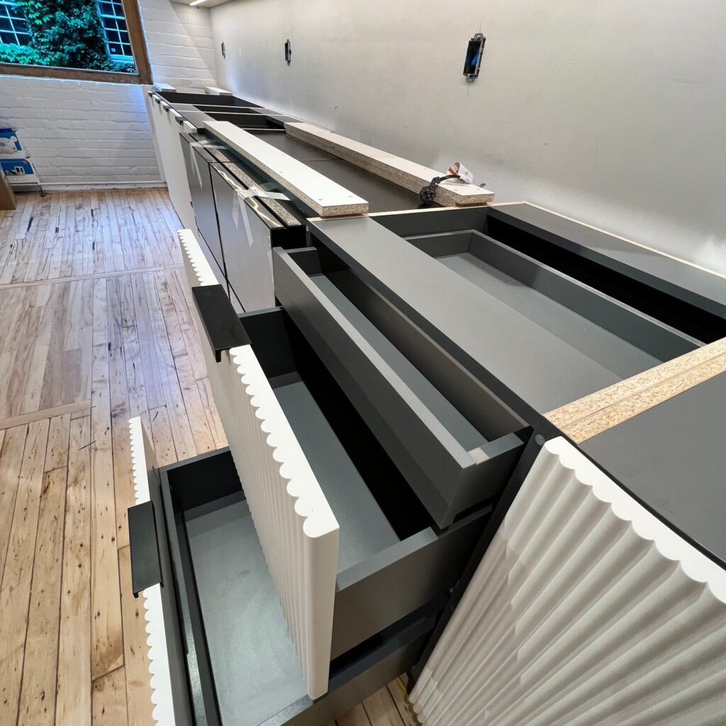 Custom kitchen cabinetry with pull-out storage and integrated shelving system
