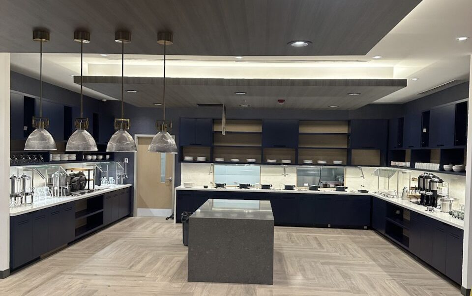 Custom hotel buffet millwork installation at Hyatt Place Toronto Airport with modern cabinetry, service counters, and wood ceiling design