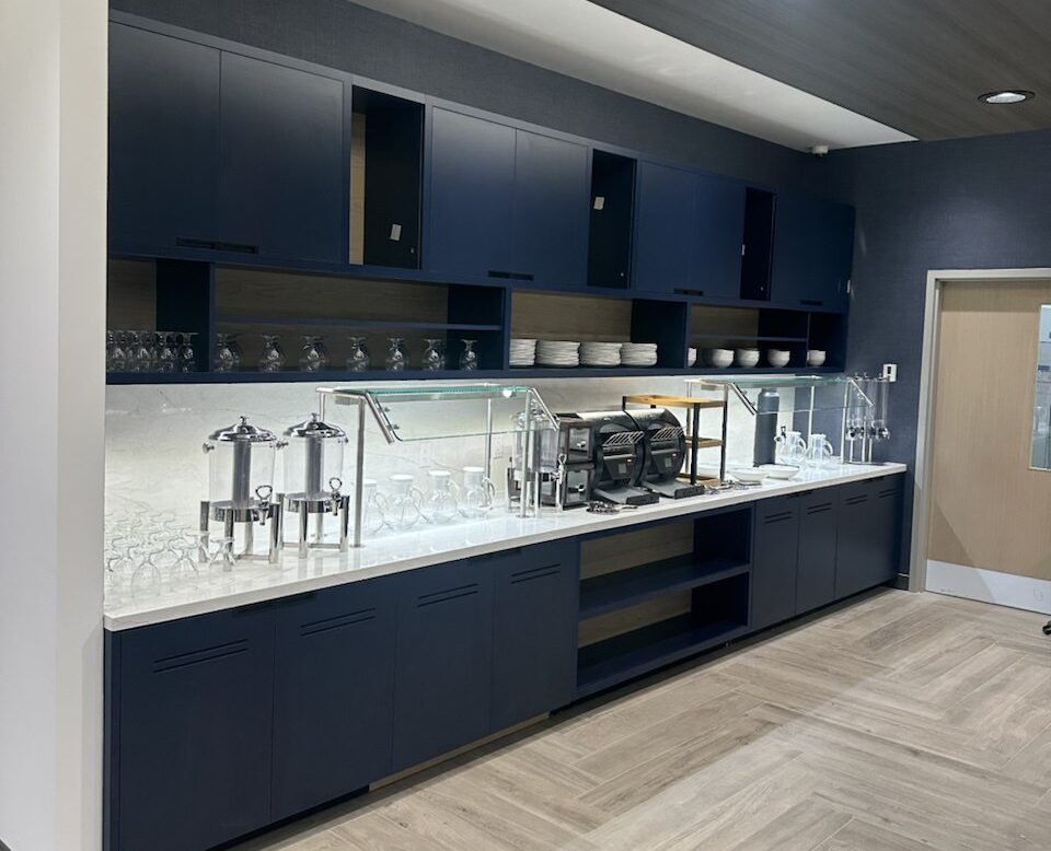 Custom hotel buffet cabinetry millwork installation in Toronto featuring modern commercial storage cabinets, stone countertops, and integrated serving station