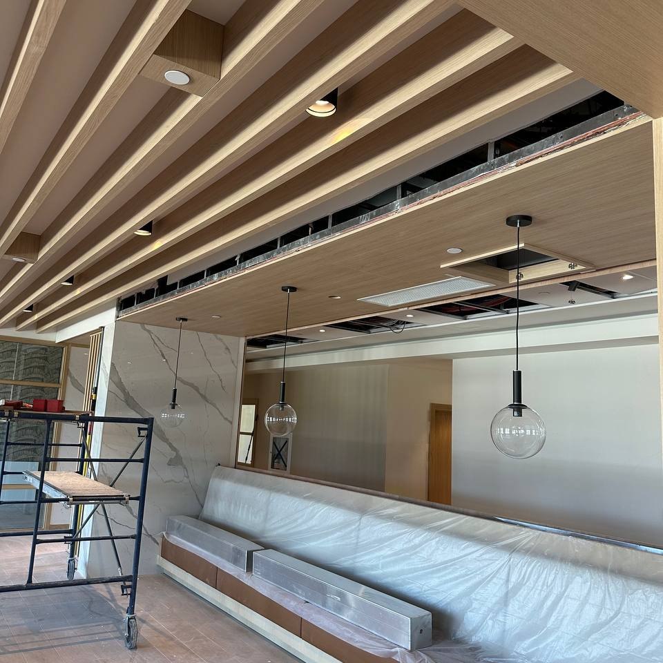 Custom wood slat ceiling millwork installation in North York, ON restaurant